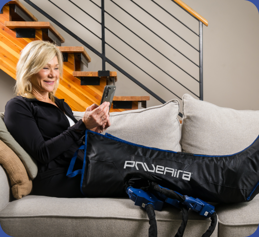 A patient adjusting her PnueAira compression garment at home